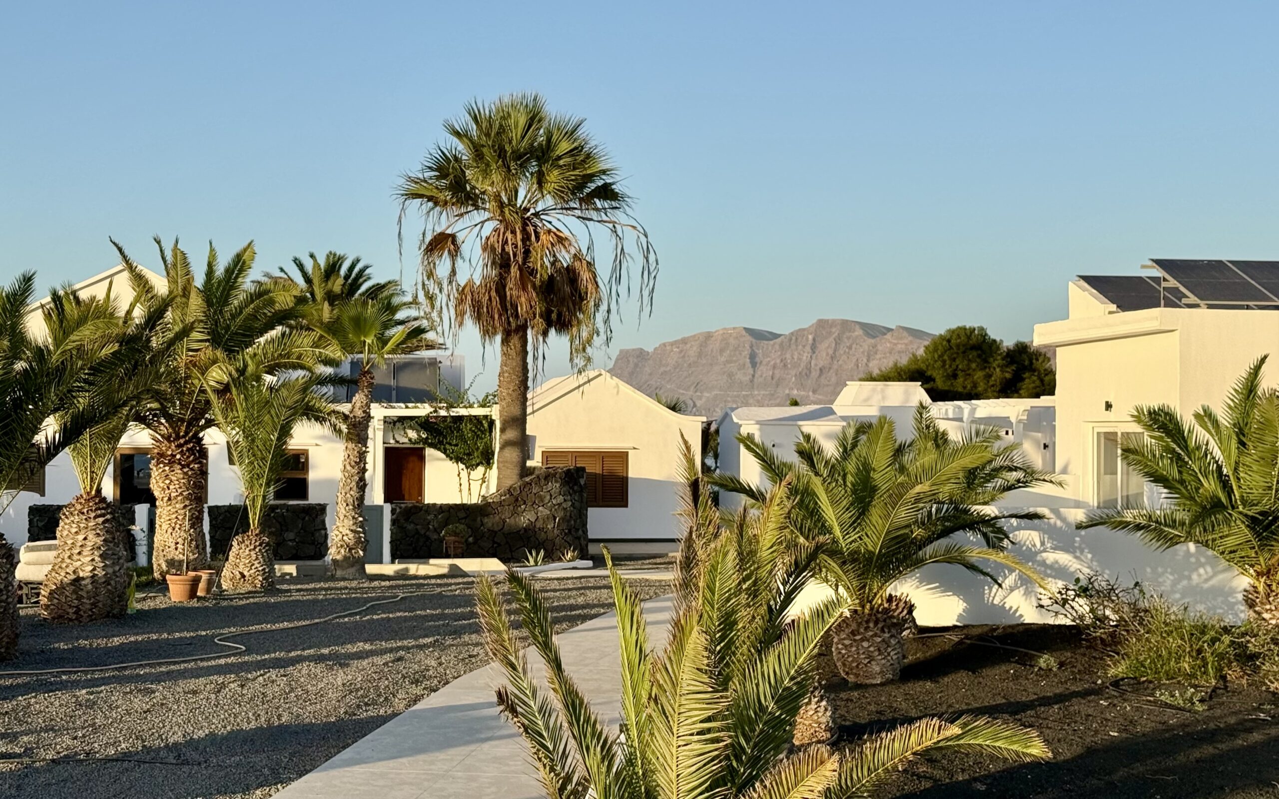 Pipa Suites villa with the Famara cliffs behind